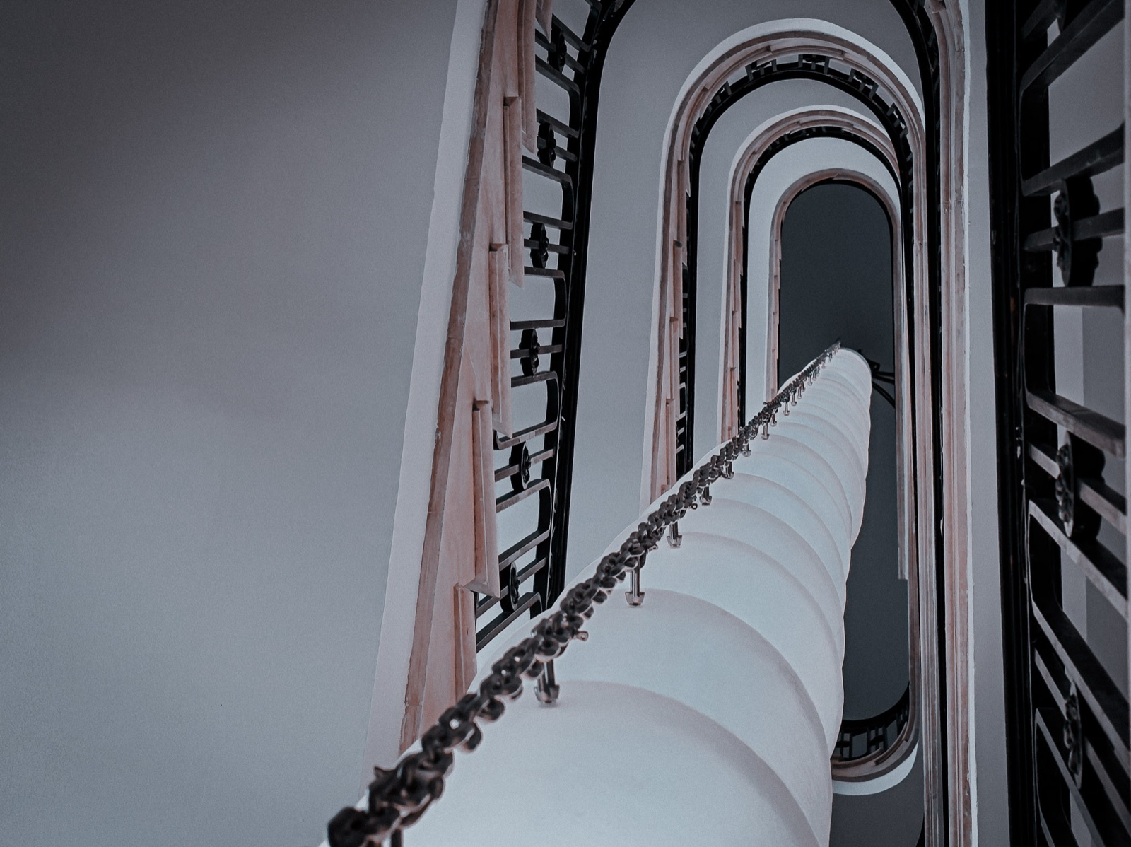 Spiral staircase tunnel receding into the distance